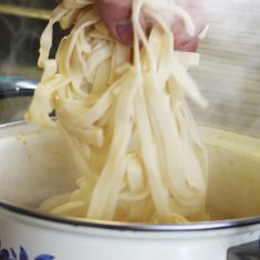 沸騰したら火を弱める。箸が通るくらいかぼちゃがやわらかくなったら、ほうとうを加える。ほうとうはくっつきやすいため、軽く水洗いをして表面の粉を落とし、手でほぐしながら入れ、入れたらすぐに勢いよくかき混ぜる。
