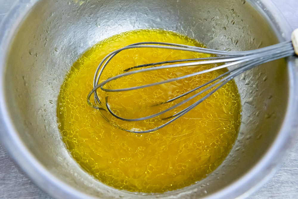 みかんを絞る。その絞り汁に、酢、塩、コショウ、オリーブオイルを加えてよく混ぜる。みかんの味を見て酸味が足りなければ酢を増やす。