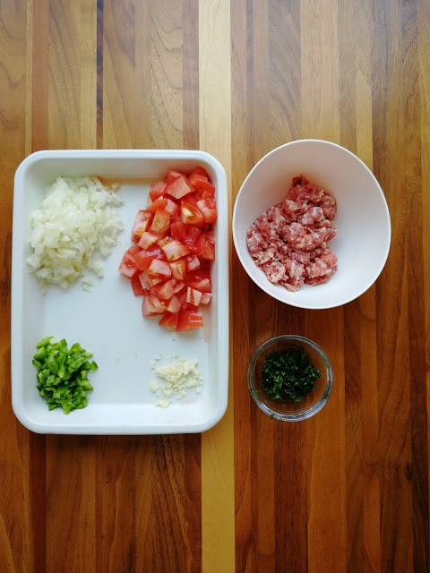 ラム肉は薄切りの場合は細かく刻む。にんにく、玉ねぎとピーマン、パセリはみじん切り。トマトはざく切り。