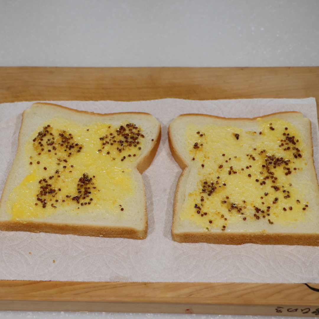 食パンにバターとマスタードを塗る