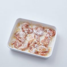 鶏もも肉にフォークで穴をあけ、バットにのせ、塩、黒こしょう少々、にんにくすりおろし、卵黄を揉みこみ、薄力粉をまぶす。