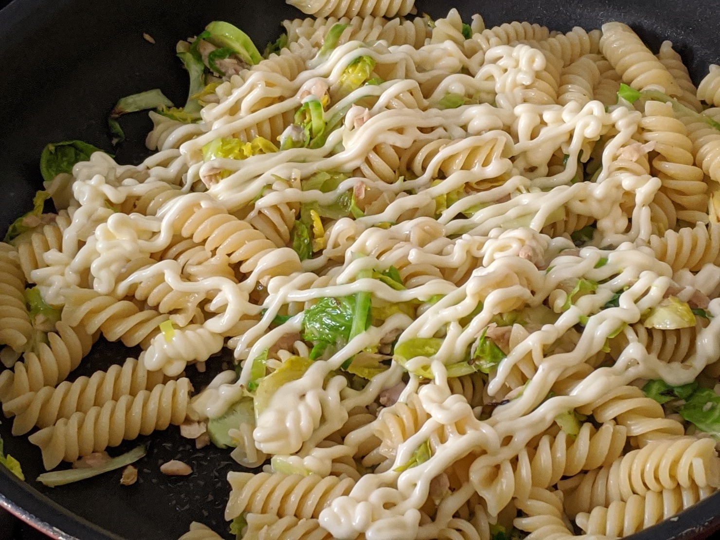 フライパンを温めオリーブオイルで細切りした芽キャベツ、ツナ缶を塩コショウで少々炒め、茹でたパスタを加え、a調味料を混ぜてカットしたゆで卵を混ぜる