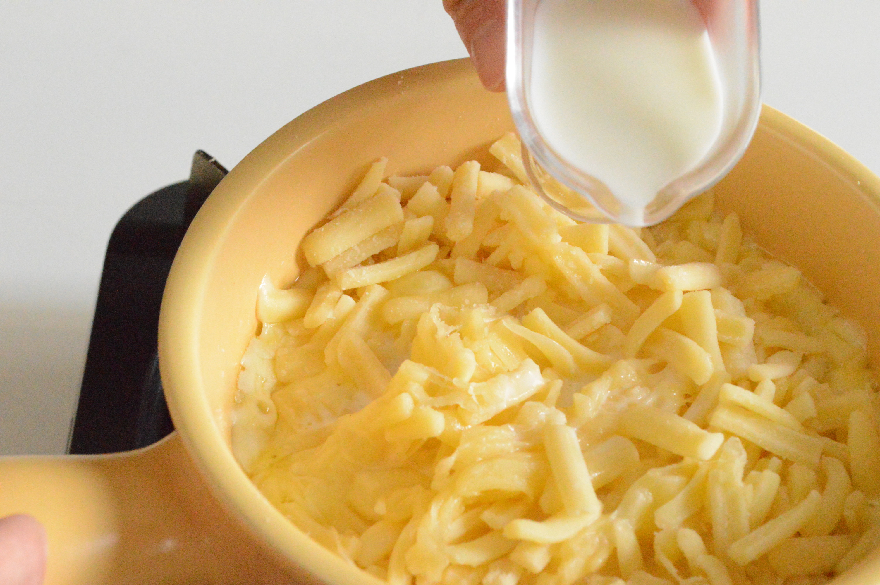 小鍋にピザ用チーズを入れ弱火にかけ、溶け始めたら牛乳を少ずつ加え混ぜる。