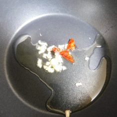鍋に油を入れ、にんにくと、鷹の爪をいれて、香りを出す。